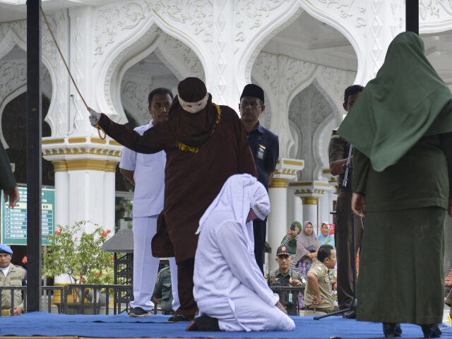 Woman being flogged_Sharia law An Indonesian woman is whipped in public in Banda Aceh on March 4, 2019. Six couples were