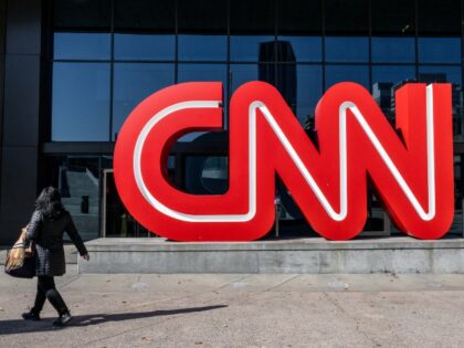 ATLANTA, GEORGIA - NOVEMBER 17: A person walks past the headquarters for the Cable News Ne