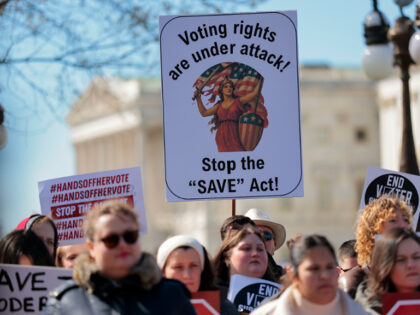 WASHINGTON, DC - MARCH 18: Attendees hold signs advocating for voting rights and against t