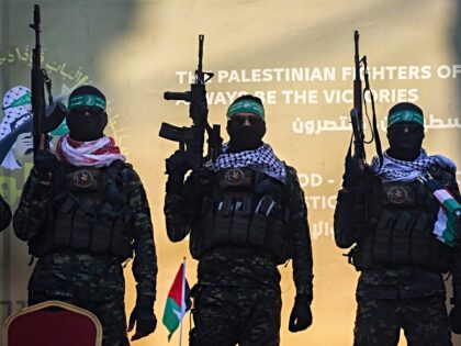 Hamas militants stand on a stage before releasing Isreali hostage Agam Berger to a Red Cro