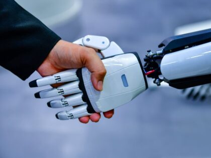 human and robot shake hands