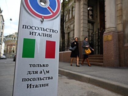 Women walk past the Italian embassy in Moscow on May 18, 2022. Moscow on May 18, 2022 kick