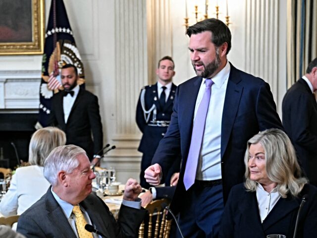 US Vice President JD Vance (C) gives a fist bump to Senator Lindsey Graham, Republican fro