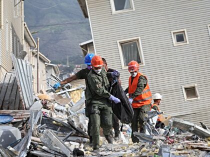 CARACAS, VENEZUELA - JUNE 30: Rescuers carry the body of a victim at a collapsed building