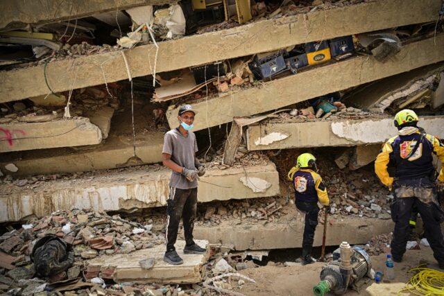 Raul Alvarado searches for missing relatives amid rubble in the seaside city of Caraballed