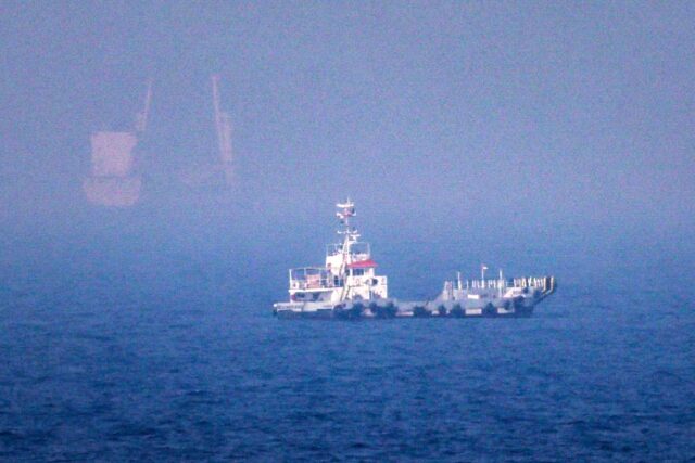 Ships sail near the Strait of Hormuz off the eastern coast of the United Arab Emirates at