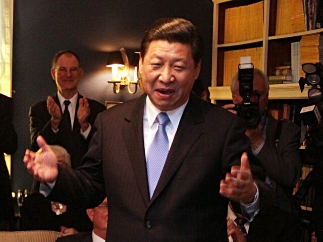 Chinese Vice President Xi Jinping jokes in the home of Roger and Sarah Lande in Muscatine,