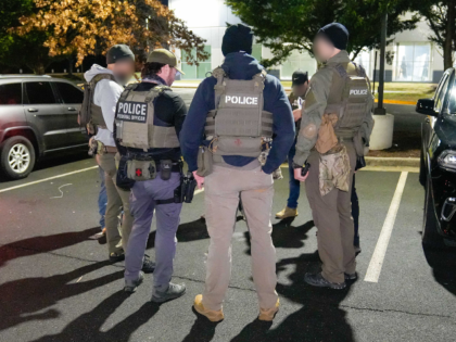 Federal law enforcement officials conduct a pre-operational briefing in a Washington, D.C.