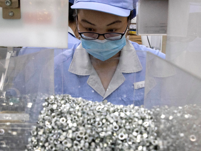 In this Wednesday, May 13, 2020 photo, a worker at SMC China, a Japanese joint venture pne