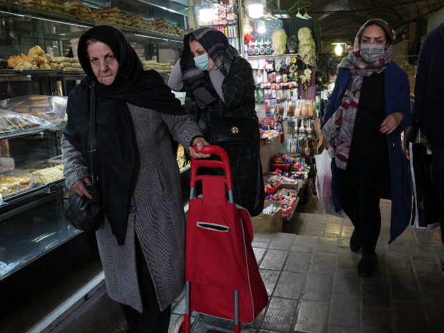 AP23057604054409 People walk at the old grand bazaar of Tehran, Iran, Sunday, Feb. 26, 2023. Iran's cu