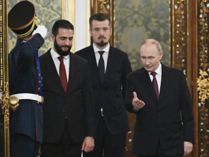 Russian President Vladimir Putin, left, welcomes Syrian interim President Ahmad al-Sharaa,