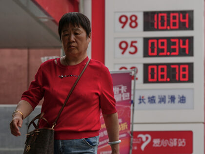 Title: China Iran US Oil Prices Image ID: 26146198766167 Article: A woman walks by a sign