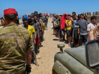 Title: Spain Ceuta Image ID: 26214573498604 Article: Migrants who crossed into Spain from Morocco line up for water distributed by Spanish soldiers in the Spanish enclave of Ceuta, Sunday, Aug. 2, 2026. (AP Photo/Bernat Armangue)