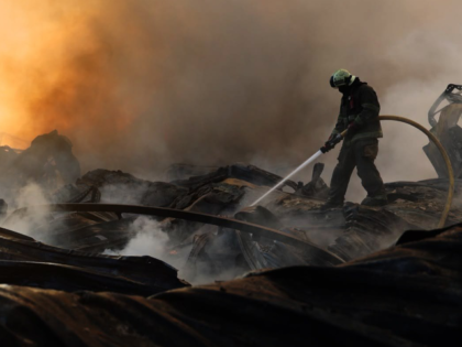 In this photo provided by the Ukrainian Emergency Service, a firefighter puts out a fire f