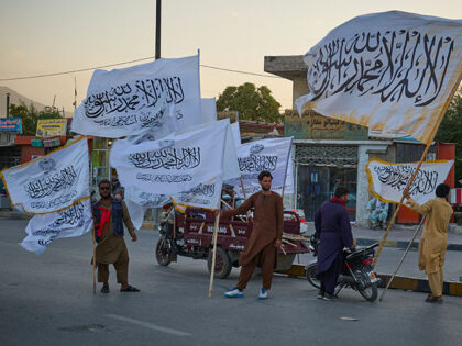 Title: Afghanistan Taliban 5th Anniversary Image ID: 26226629224485 Article: Men sell Tali