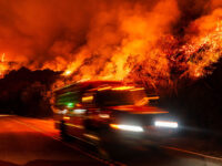 Title: Wildfires burn along California's scenic Big Sur coast, in photos Image ID: 26241239927400 Article: A firetruck passes as a wildfire called the Plaskett Fire burns towards Highway 1 on Friday, Aug. 28, 2026, in Big Sur, Calif. (AP Photo/Ethan Swope)