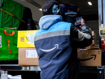 A worker scans an Amazon package on a Prime delivery truck in New York, US, on Tuesday, Oc