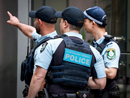 Australian Federal Police (AFP) officers and New South Wales police officers stand outside