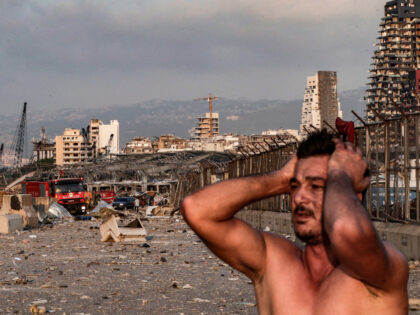 A man reacts at the scene of an explosion at the port in Lebanon's capital Beirut on
