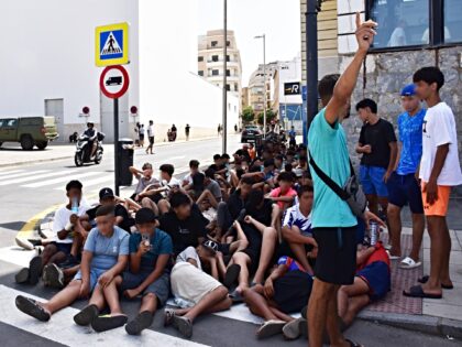 CEUTA, SPAIN - AUGUST 10: A group of minors wait to be registered at a National Police sta
