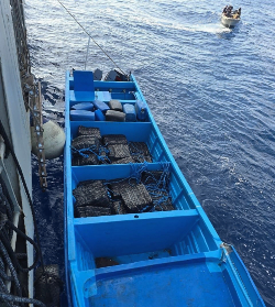 A go-fast vessel carrying 1,800 kilos of cocaine floats next to a law enforcement vessel just off the Pacific Coast of Chiapas, Mexico, July 25 following an interdiction operation conducted by ICE’s Homeland Security Investigations Houston, HSI Mexico City, and Mexico’s Secretaría de Marina. (U.S. Immigration and Customs Enforcement)