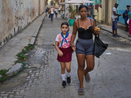 A woman accompanies a student to school in Havana, Cuba, Friday, March 13, 2026. Ramon Esp