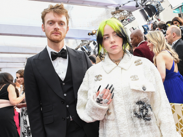 GettyImages-1199748520 Singer Billie Eilish (R) and her brother Finneas arrive for the 92nd Oscars at the Dolby T