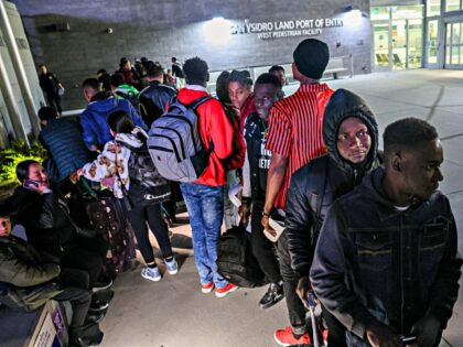 San Ysidro, CA, Thursday, April 25, 2024 - Lovenstar, a Haitian rap artist, right, waits f