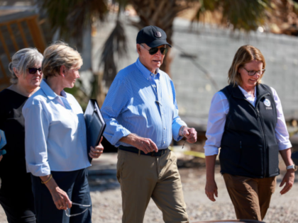 ST PETE BEACH, FLORIDA - OCTOBER 13: U.S. President Joe Biden walks with Deanne Criswell (
