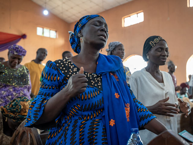 Worshippers pray at the Evangelical Church Winning All (ECWA) during a prayer called by th