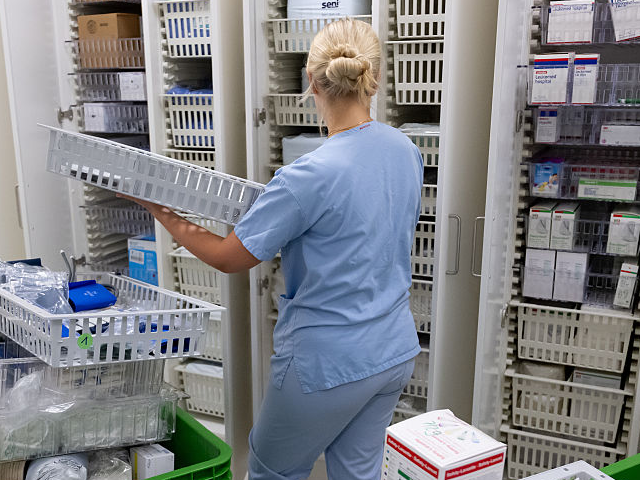 GettyImages-2280063948 09 June 2026, Bavaria, Munich: A member of staff sorts consumables into a cupboard after t
