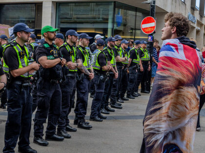 OXFORD, UNITED KINGDOM - 2026/06/17: A young Tommy Robinson supporter wrapped himself in a