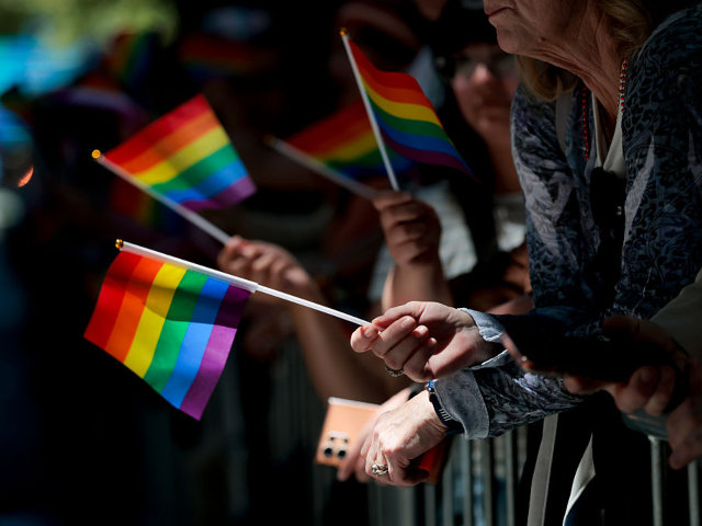 SAN FRANCISCO, CALIFORNIA - JUNE 28: Onlookers wave pride flags during the 56th annual SF