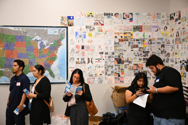 Job seekers wait in line for free resume preparation services as they attend a Inspire Tog