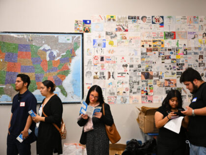 Job seekers wait in line for free resume preparation services as they attend a Inspire Tog