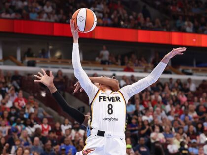 The Indiana Fever's Sophie Cunningham (8) is fouled by the Chicago Sky's DiJonai Carringto