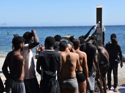 CEUTA, SPAIN - AUGUST 05: Several people are washing themselves in the public showers on T