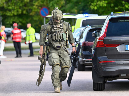 Police special forces work at the scene where an attacker with a sword wounded several peo