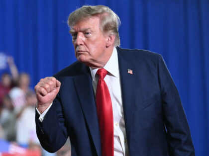 US President Donald Trump clenches his fist after speaking at a campaign rally for US Sena