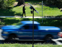 SILVER SPRING, MD - AUGUST 19: Traffic flows past an Axon brand automatic license plate reader (ALPR) camera in the median of 16th Street near the border of Maryland and the District of Columbia on August 19, 2026 in Silver Spring, Maryland. Law enforcement technology company Flock, which runs a nationwide network of automated license plate readers (ALPR), introduced new safety controls last week in an effort to curb scrutiny after a series of recent police officer resignations and arrests for alleged abuses of the company’s tools. (Photo by Chip Somodevilla/Getty Images)