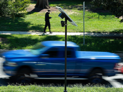 SILVER SPRING, MD - AUGUST 19: Traffic flows past an Axon brand automatic license plate re