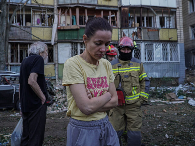 Russia Massively Strikes Kyiv KYIV, UKRAINE - AUGUST 20: Emergency service workers help residents in a yard of an apartm