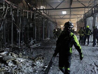 KRYVYI RIH, UKRAINE - AUGUST 22: Firefighters work at the site of a Russian drone strike o