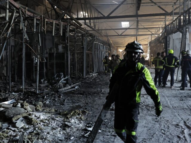 KRYVYI RIH, UKRAINE - AUGUST 22: Firefighters work at the site of a Russian drone strike o