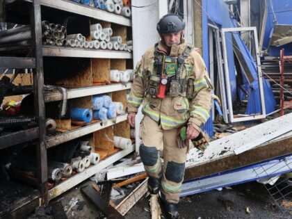 A rescuer works at an Epicenter hypermarket in the Osnovianskyi district, destroyed by a R