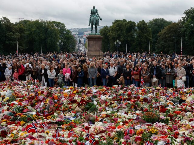 Mourners gather at a makeshift memorial to pay tribute to King Harald V of Norway who pass