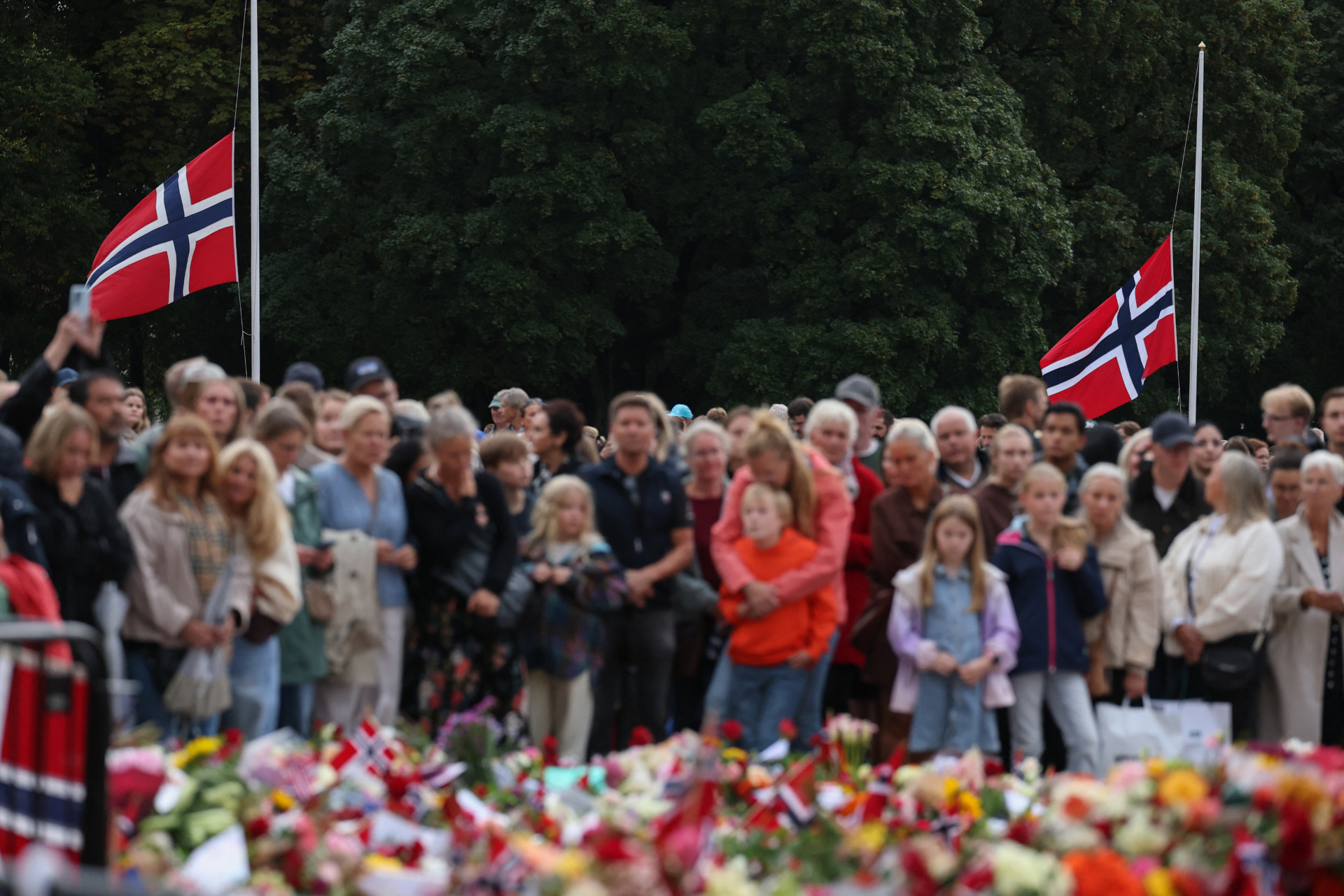 Mourners gather at a makeshift memorial to pay tribute to King Harald V of Norway who passed away, as flags are at half-mast at the Royal Palace square in Oslo on August 29, 2026. King Harald V of Norway, who died on August 28, 2026 aged 89, remained a unifying figure in his country until the very end, a pillar of stability amid a string of family scandals that tarnished the final years of his reign. (Photo by Odd ANDERSEN / AFP via Getty Images)