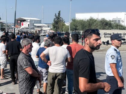 People wait for news in the aftermath of a ferry capsizing at the port of Kyrenia in the s