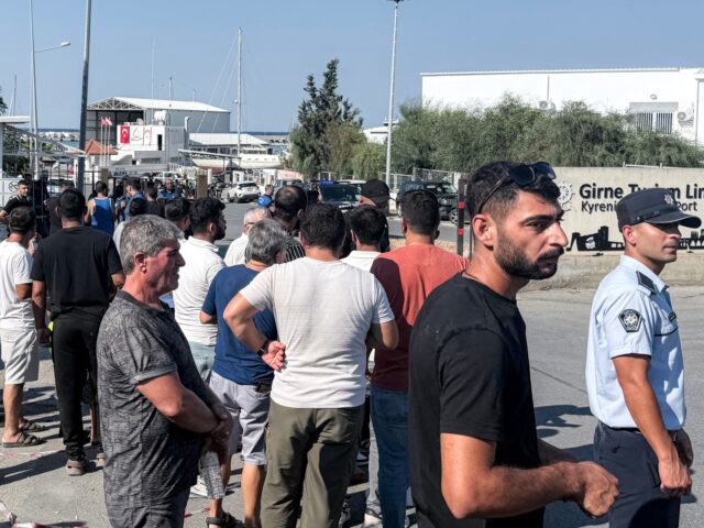 People wait for news in the aftermath of a ferry capsizing at the port of Kyrenia in the s
