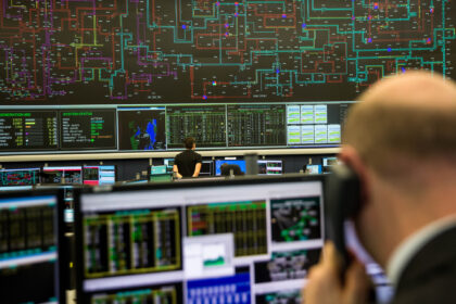 An employee monitors electricity output and usage data on a screen at the National Grid Pl